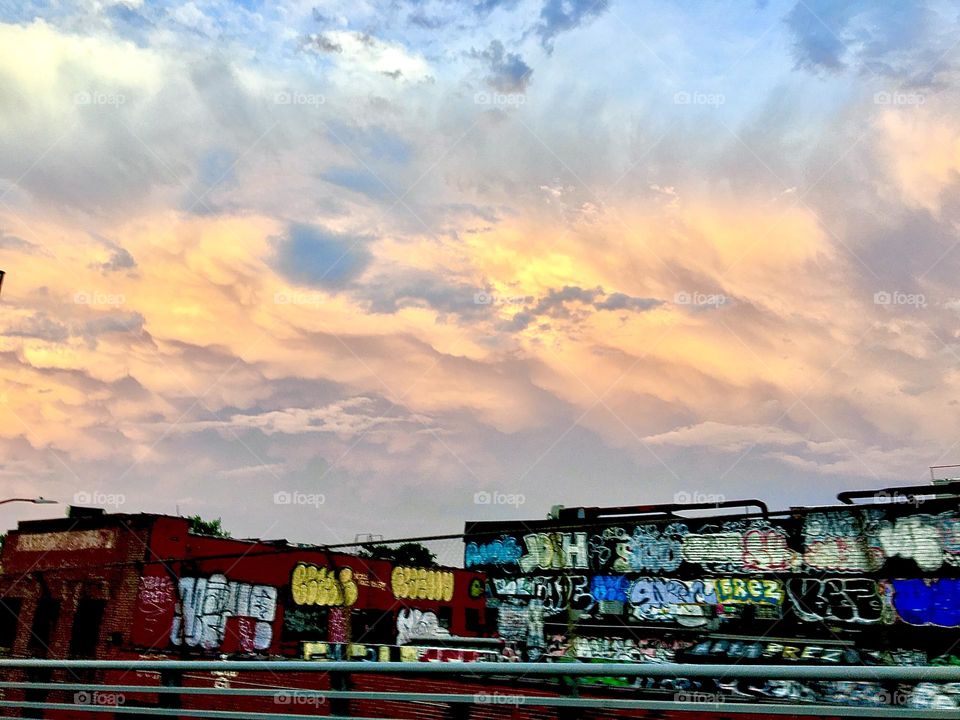 Clouds during the golden hour pick up the beautiful yellow orange to pinkish tones of the setting sun set against the lavender blue color of the sky as we approach the twilight hour and nightfall. 2021. Hypnotic Productions