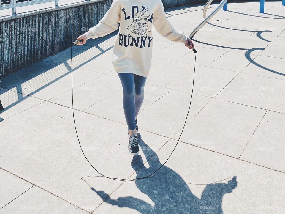 Girl jumping with rope