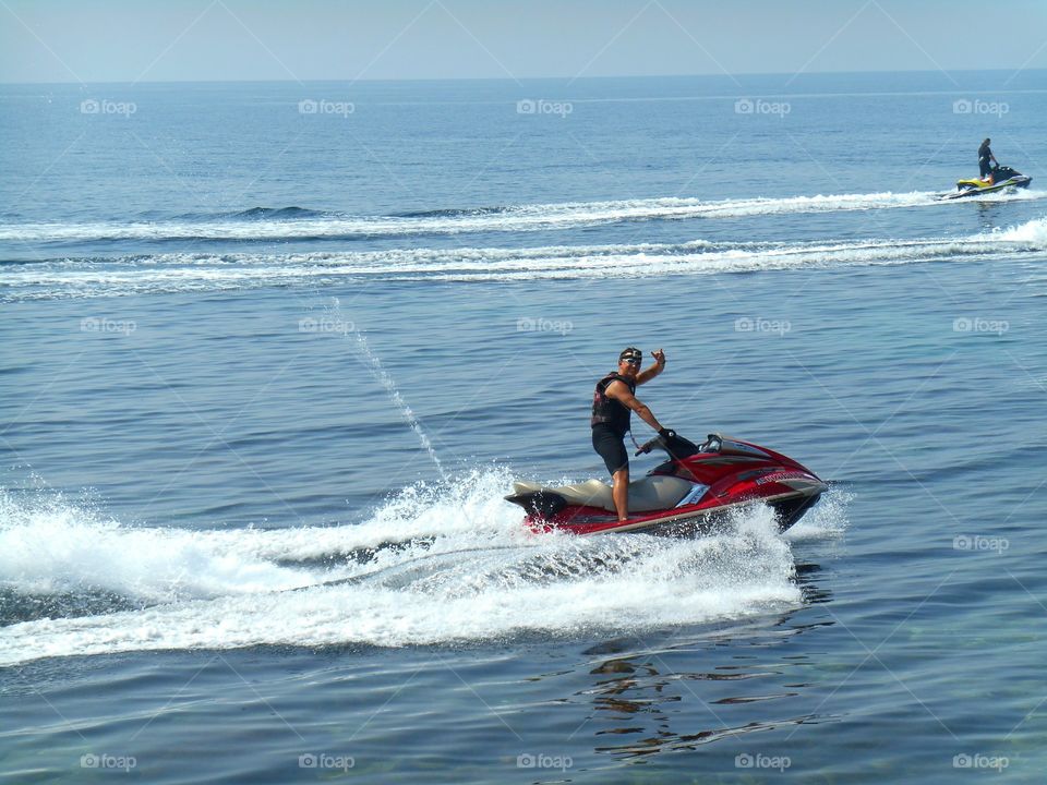 summer active men on a water bike blue sky background