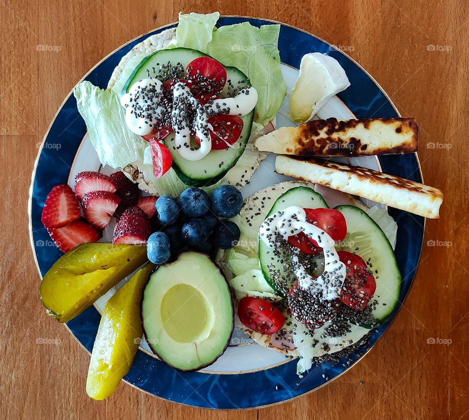 Gourmet breakfast sandwich meal with avocado, haloumi cheese and pickled cucumber