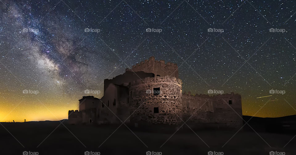 Old ruin fort against milkyway in sky