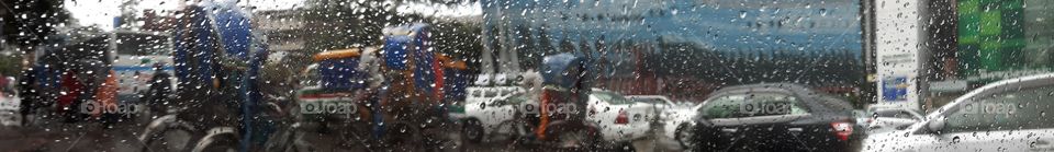 Panaromic rainy view of a busy street