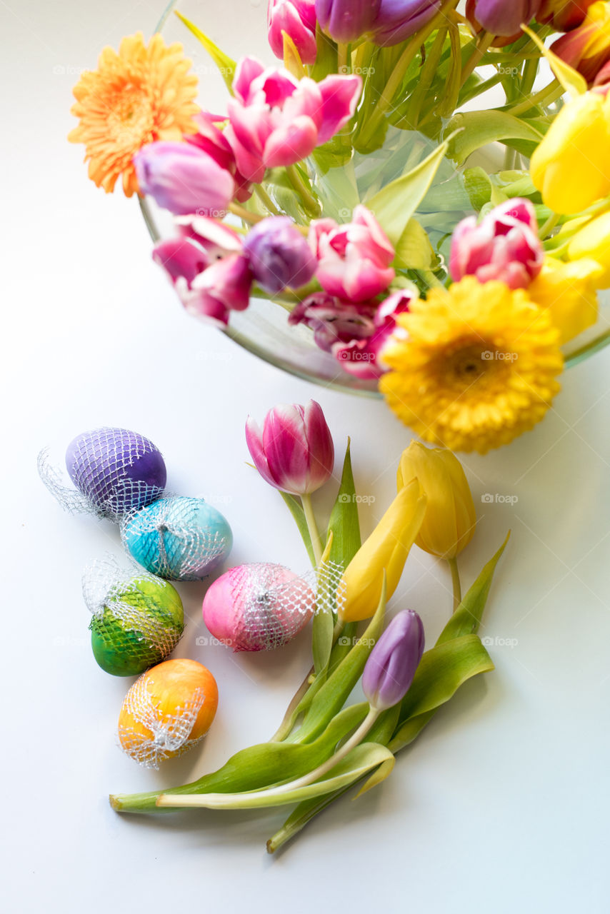 Easter time, spring flowers and colored eggs