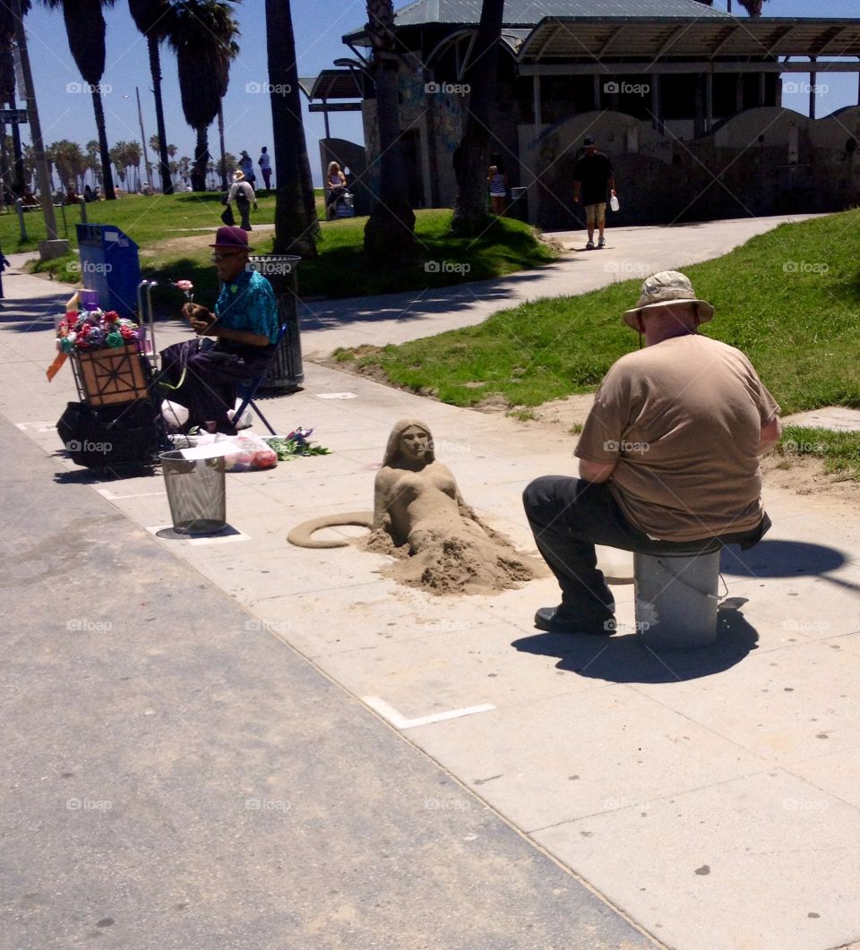 Famous Venice Beach and sand figure of Mermaid on the street