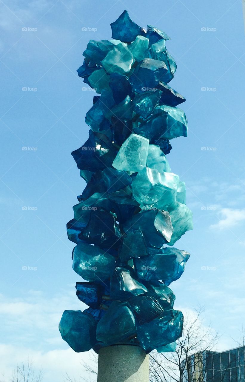Blue salt pillar. Sculpture blue chunky glass sky