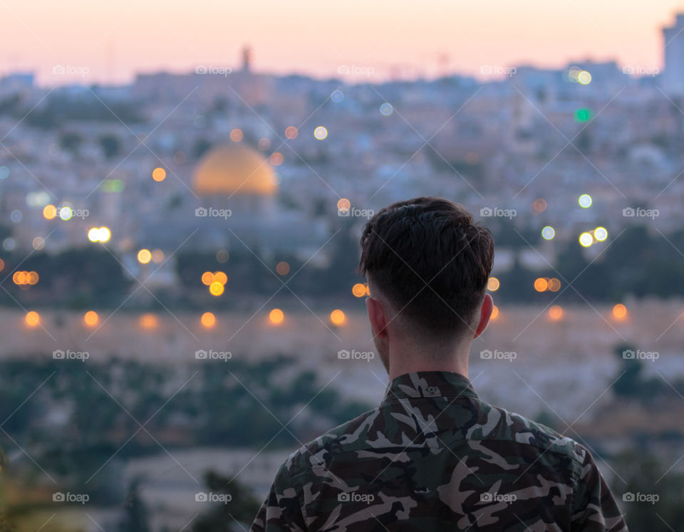 Young man looking towards Jerusalem from Mt. of Olives