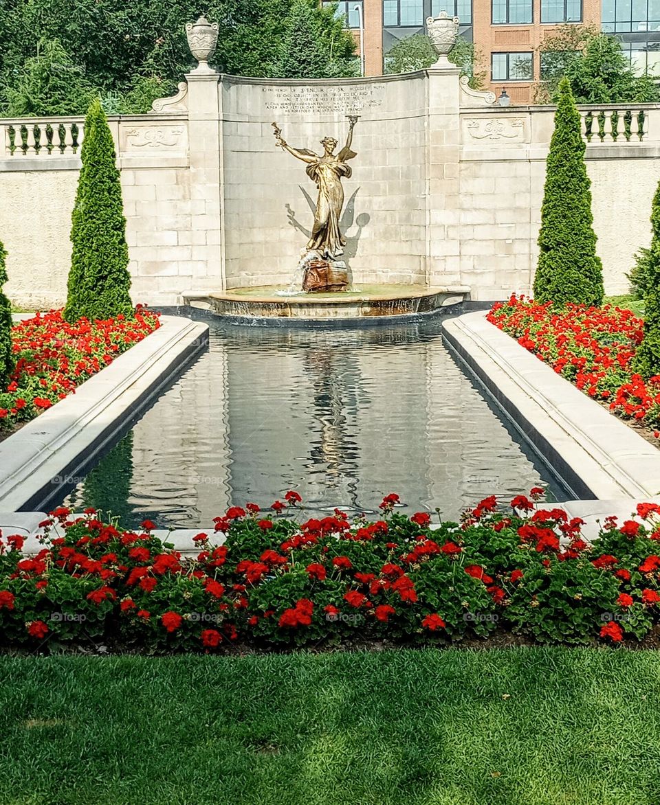 Statue with Water and Flowers