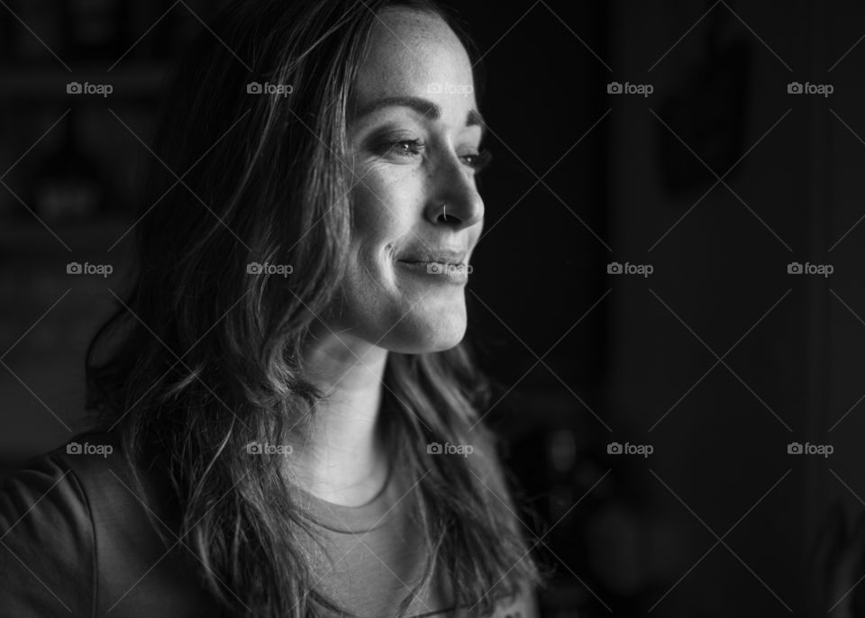 Image of a girl looking out the window and laughing. 