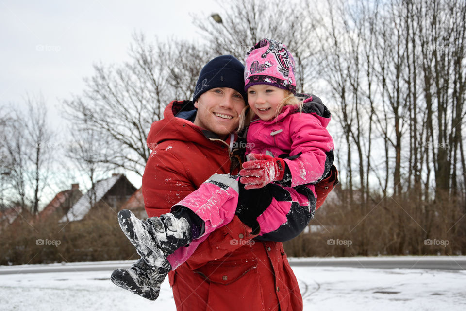 Dad of 30 years old playing with his five year old doughter in the snow in Sweden.