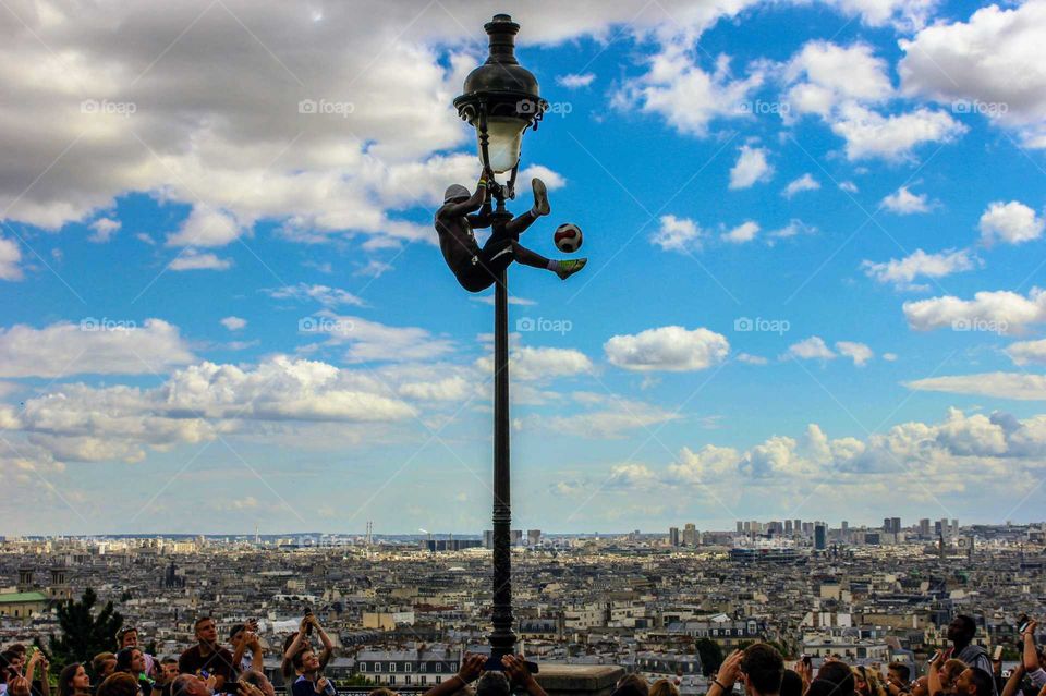 Guy plays with a ball on the light.