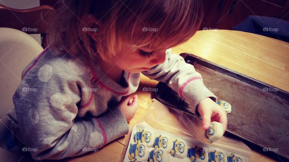 Girl arranging sweet food in plate