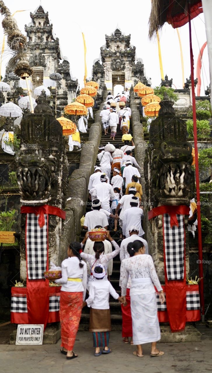 Traditional Hindu ceremony taking place in Bali, Indonesia at a gorgeous temple. 