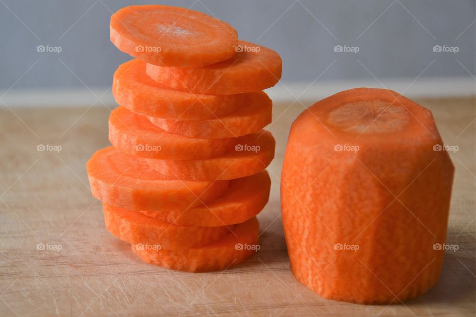 Stack of carrot slices on wood