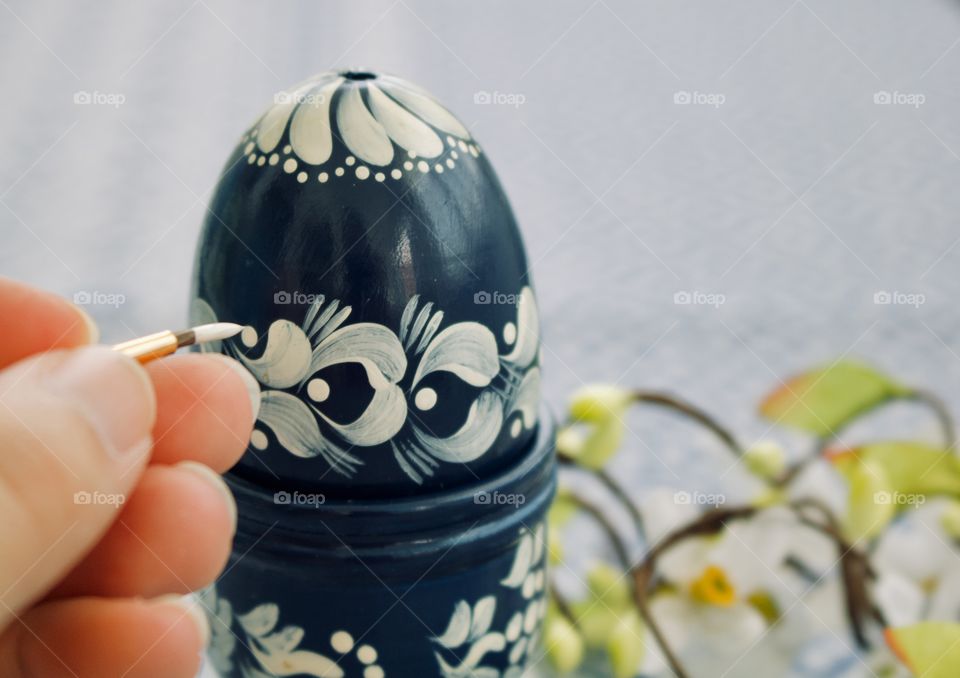 Painting an egg for Easter 