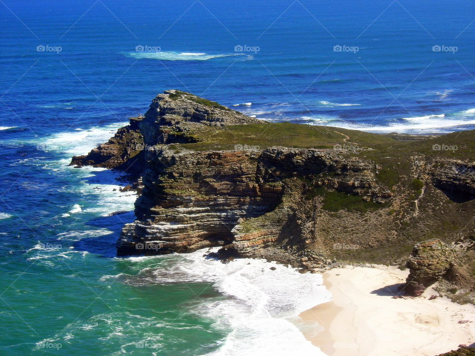 cliff , windy beach and blue ocean