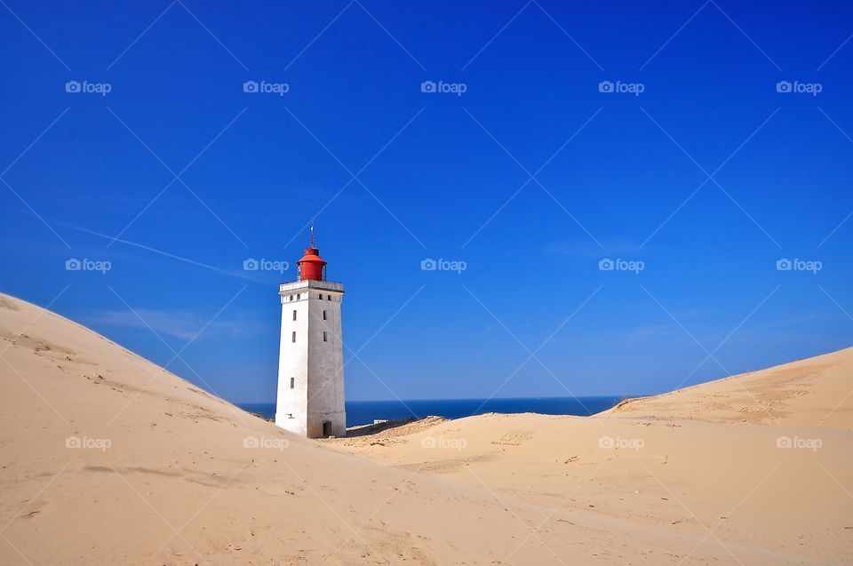 The spectacular Rubjerg Knude lighthouse in Denmark being eaten by the sand dunes