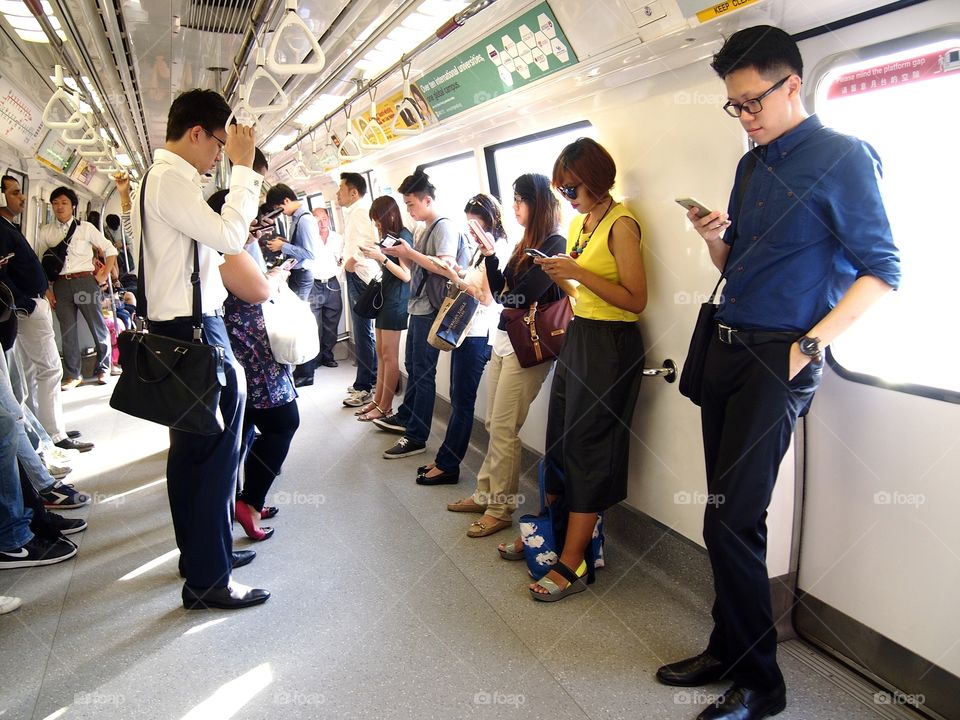 passengers inside a train using smartphone or cellphone