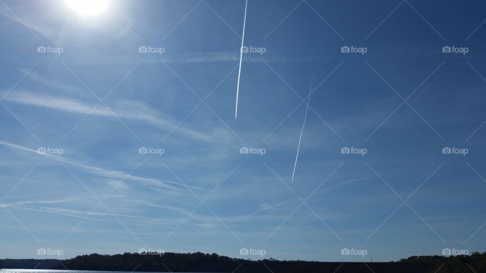 Jets flying in tandem and leaving a contrails.
