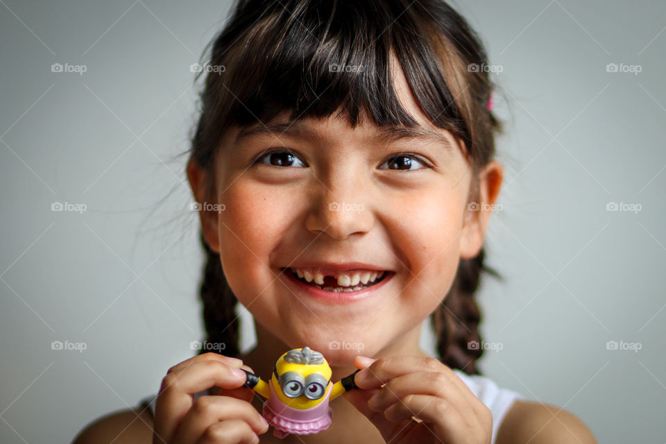 Happy little girl with her favorite toy