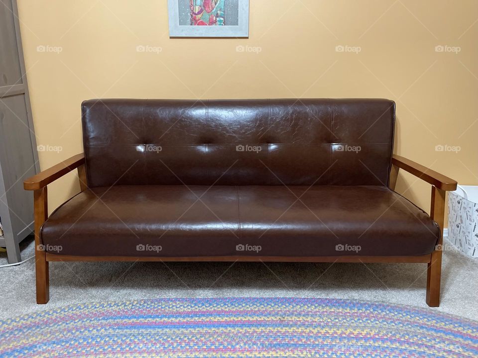 Leather couch in a bedroom, portrait of a couch, pictures of furniture 