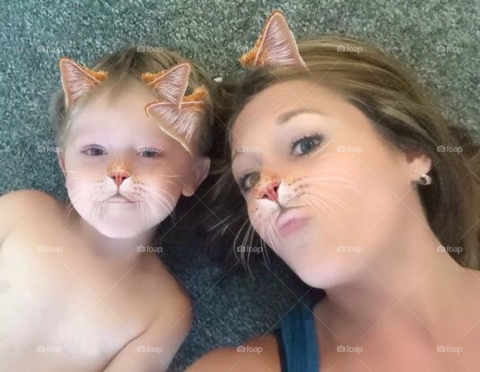 Close-up of a mother and daughter with cat makeup