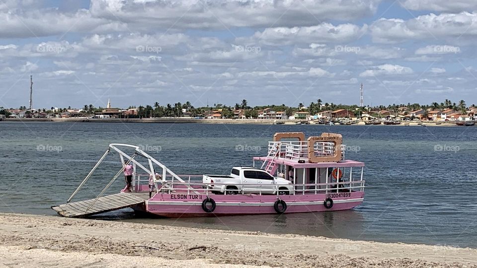 River transportation. Car on boat. 