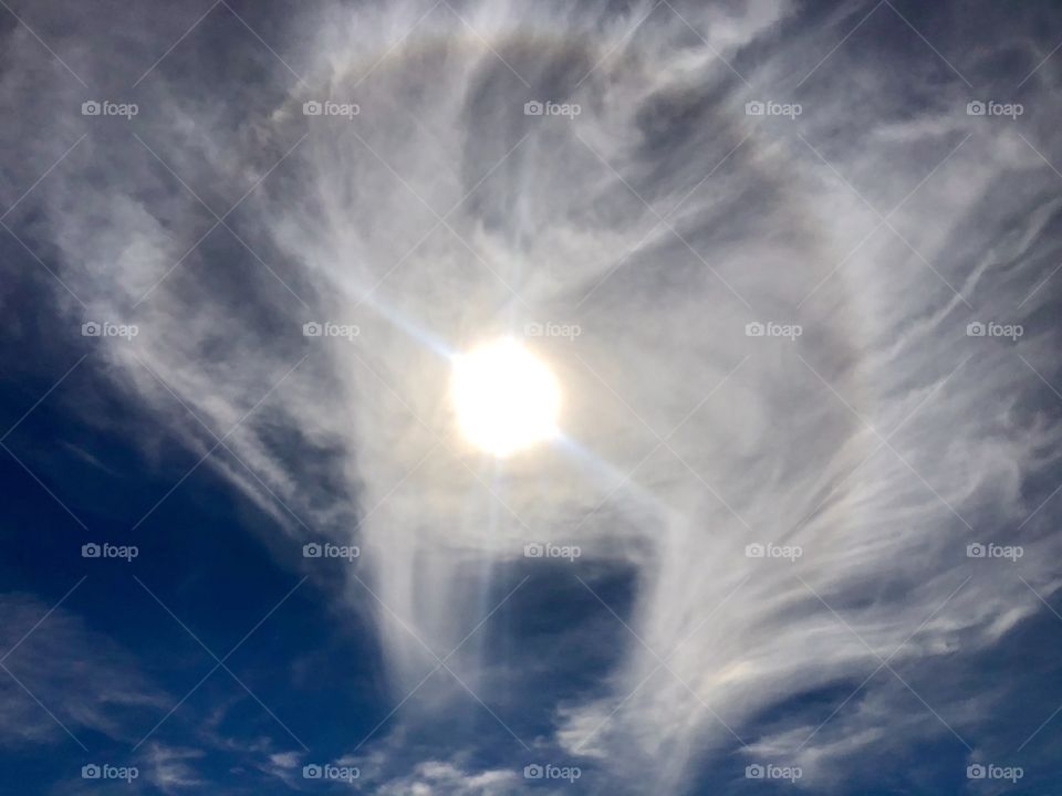 Rainbow sun halo on bright winter day at the beach 
