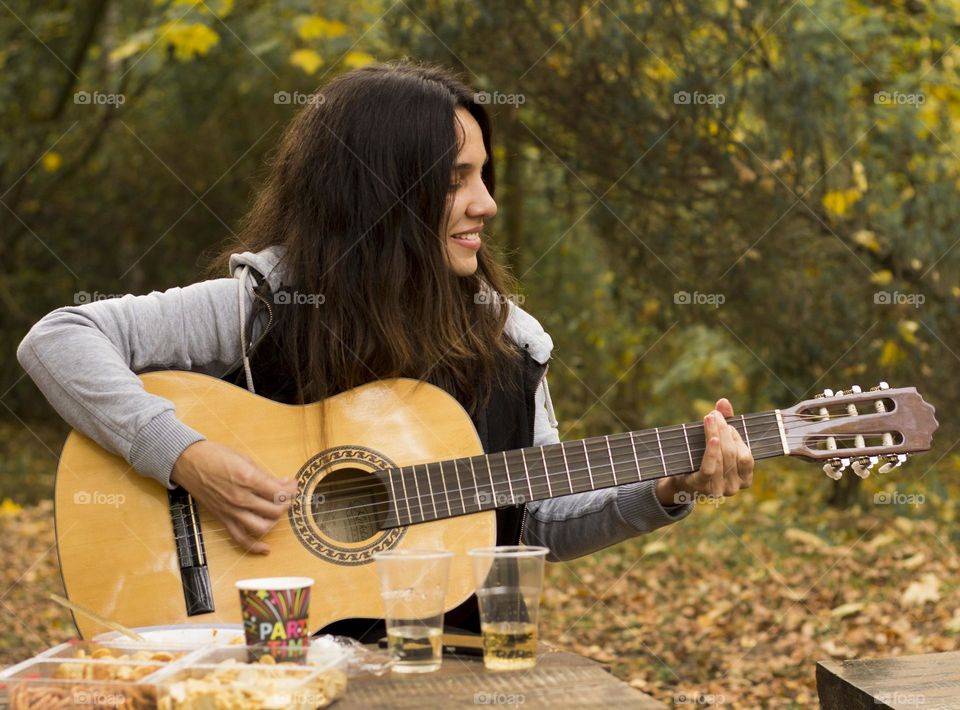 Woman playing a guitar