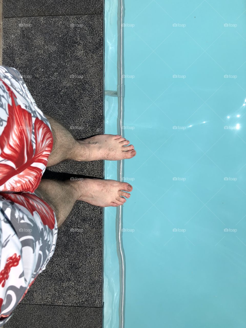 Man Standing on the edge of a pool