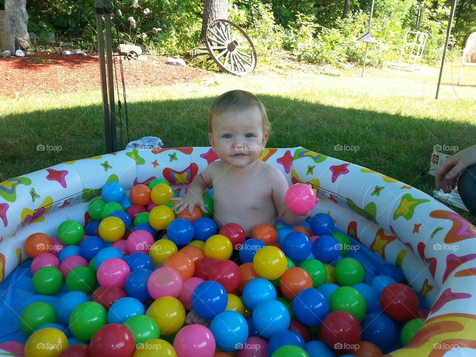 Baby boy in Ball bit.  Country background