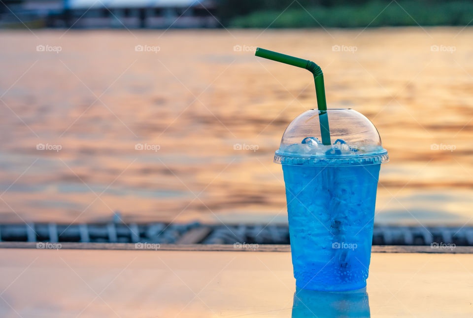 Italian soda cold Blur background Khwae Noi river And sunset light