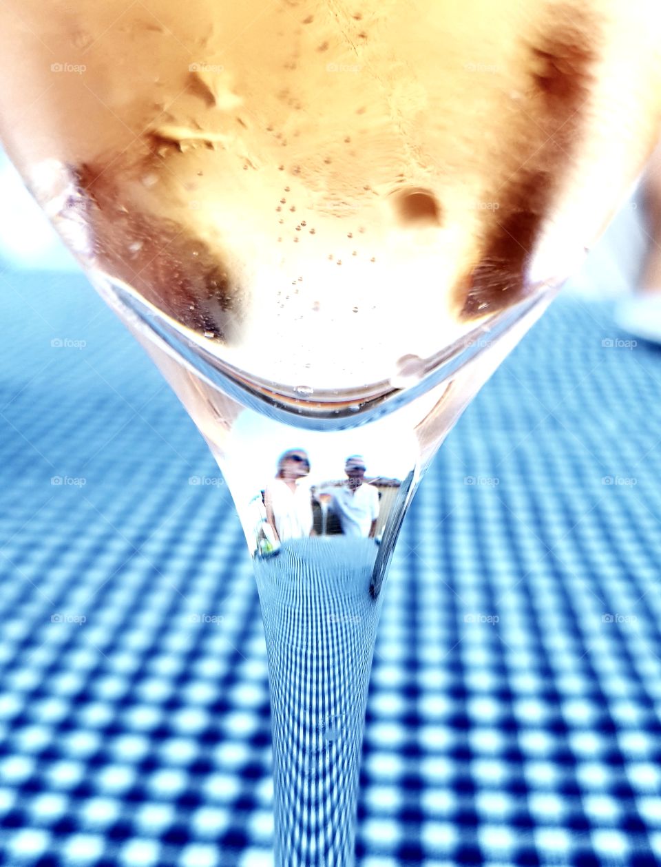 Two people visible through a wine glass