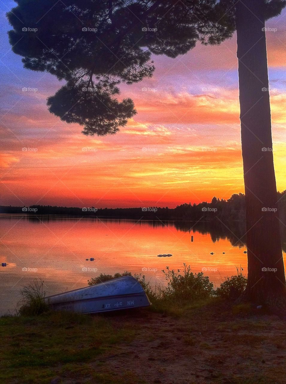 Cloud reflecting on lake at sunset