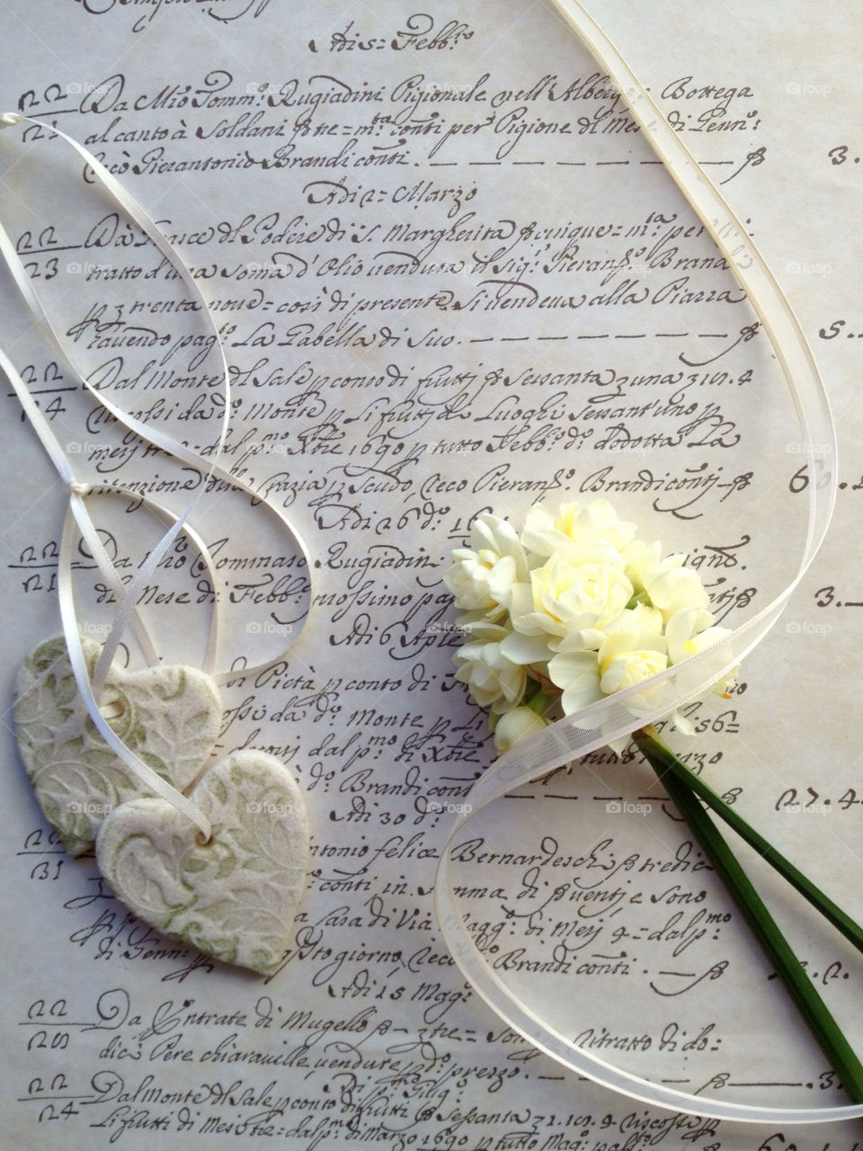 Hearts and flowers on old script