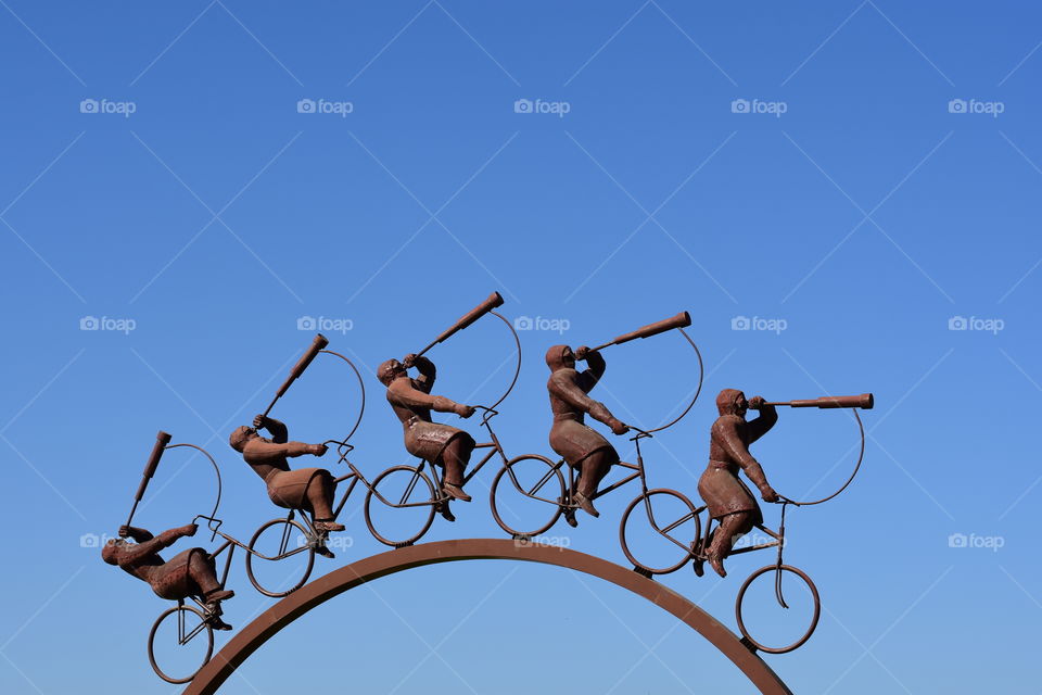 Cyclists looking at the sky monument