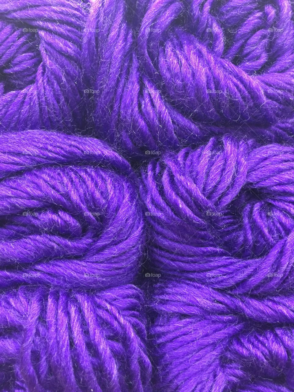 Close up of bundles of purple yarn.