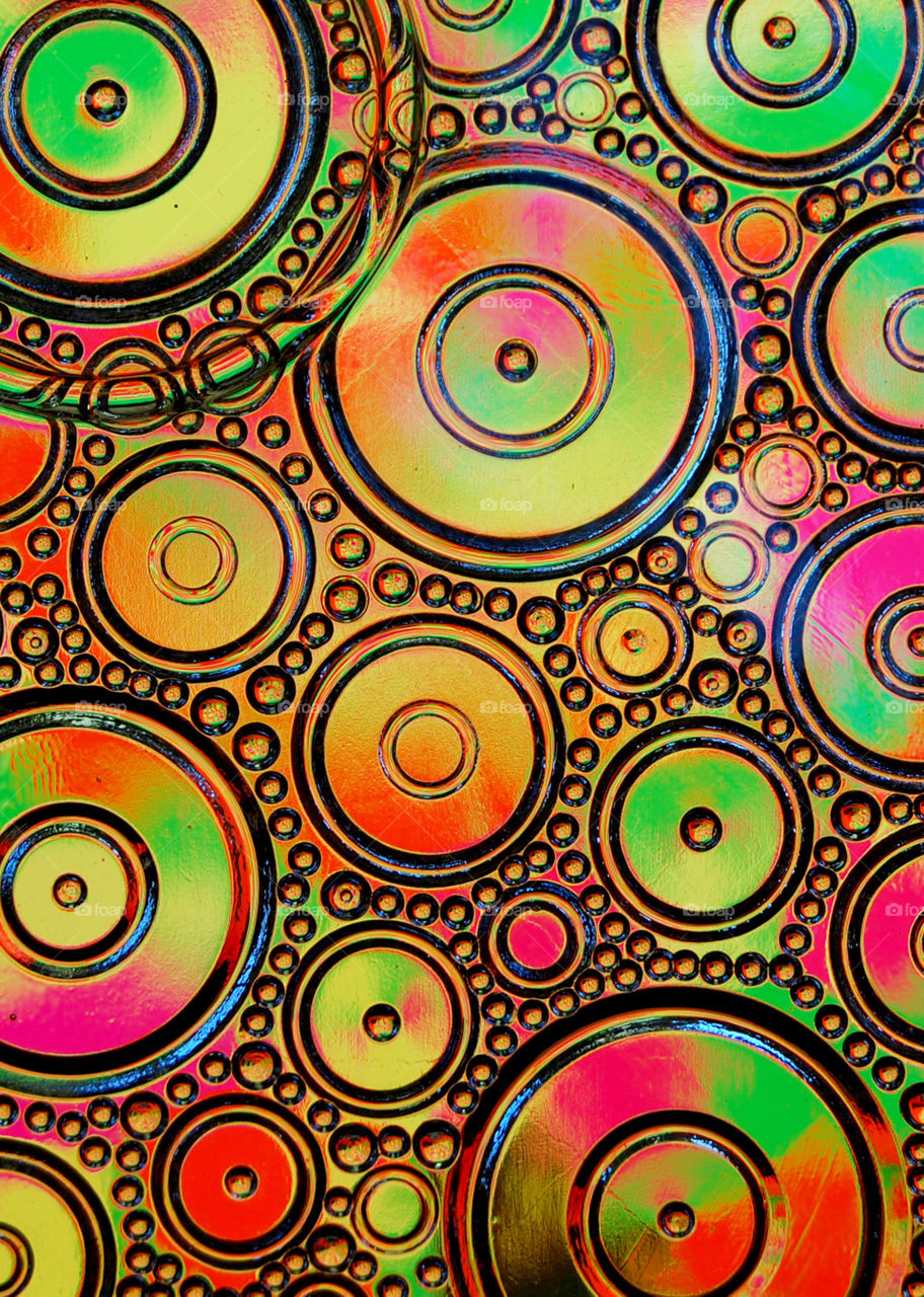 Abstract colors reflecting into facets of a glass candy dish