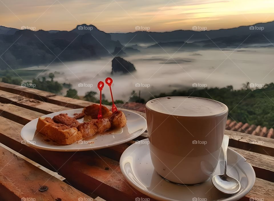 coffee and bread toast with fog of mountain