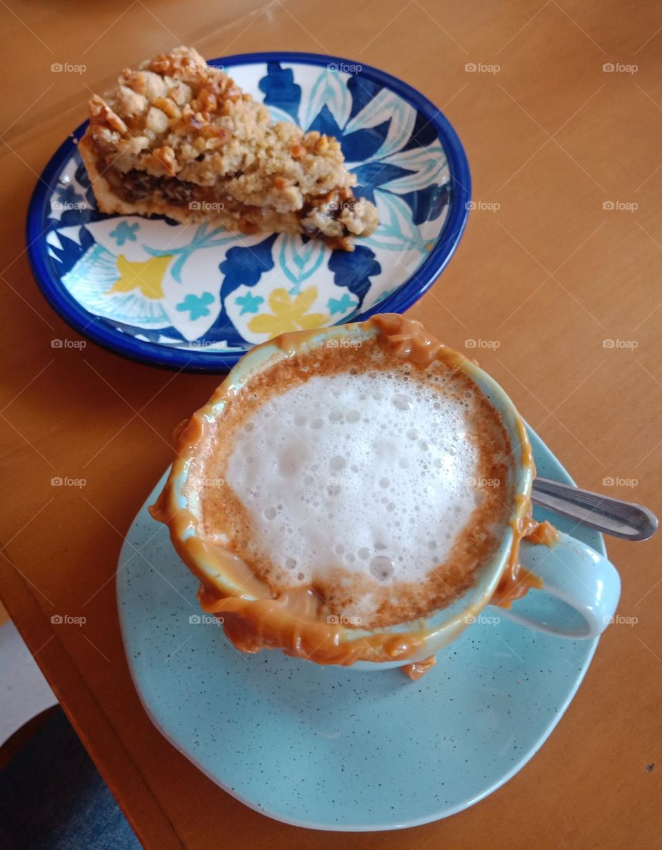 cup of caramel capuccino with fruit pie