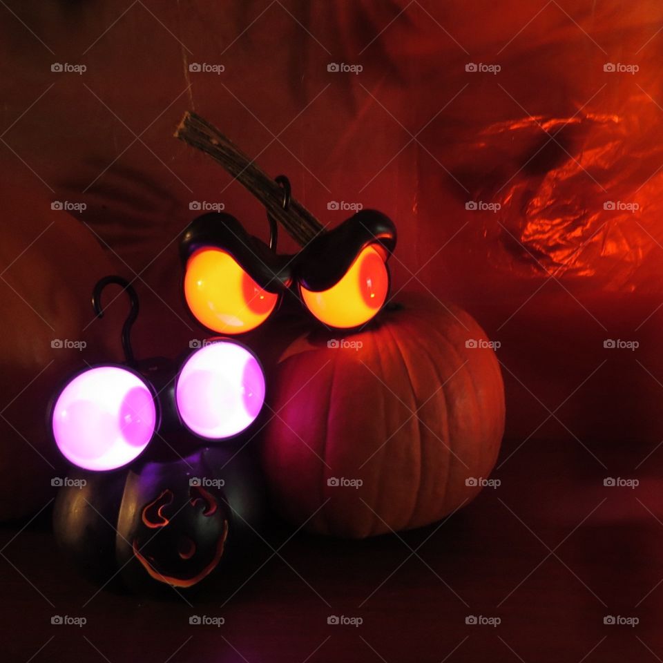 Spooky Halloween decorations with glowing eyes.