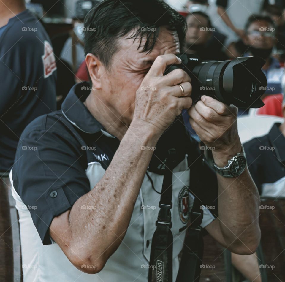 a man taking a picture using his camera