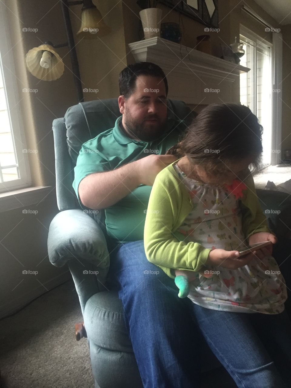 Dad braiding daughters hair