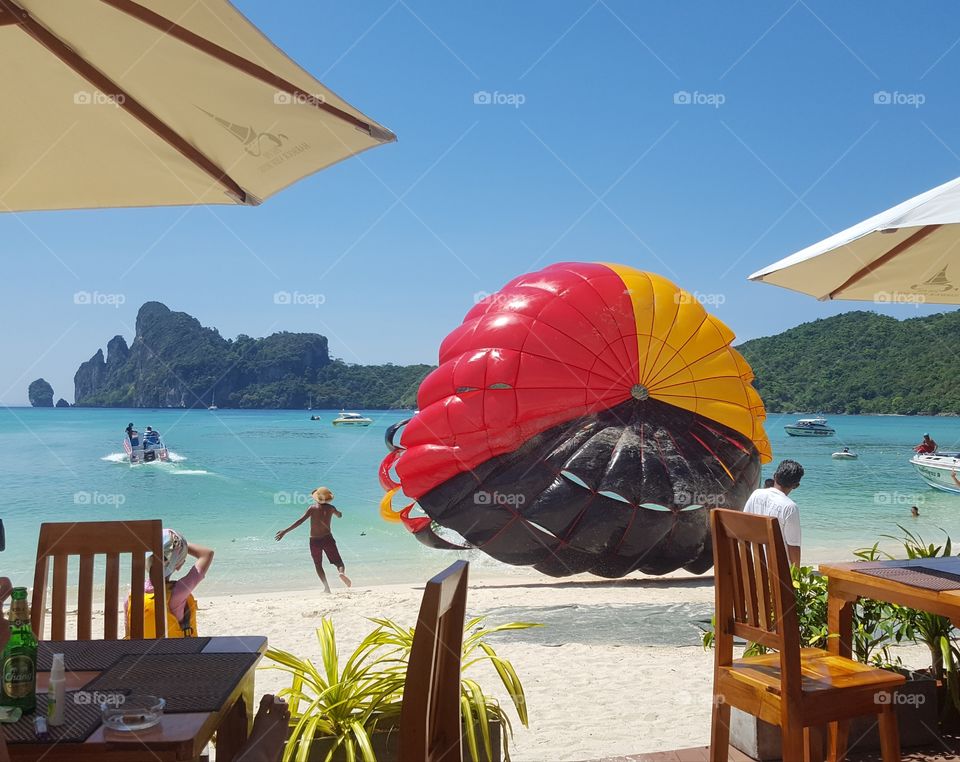 Phi Phi, Thailand and Parasailing.  Absolutely gorgeous beach and stunning scenery.