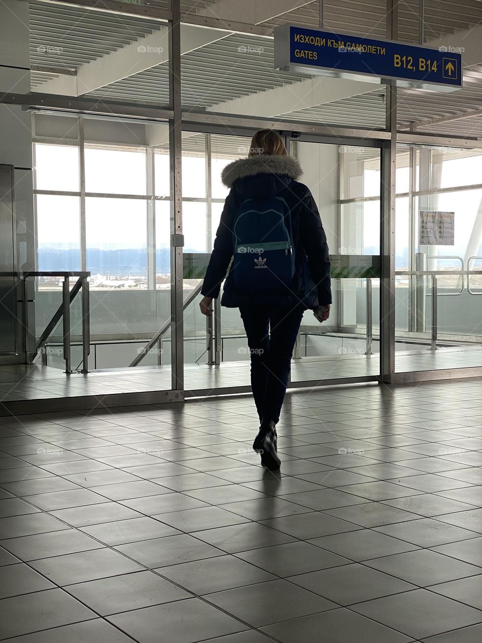 Back view of woman in front of window 