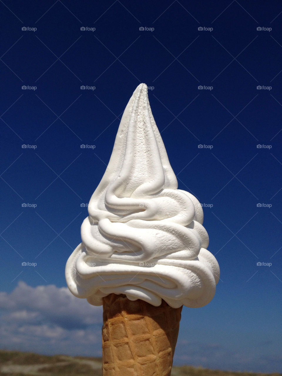 Close-up of ice cream against blue sky