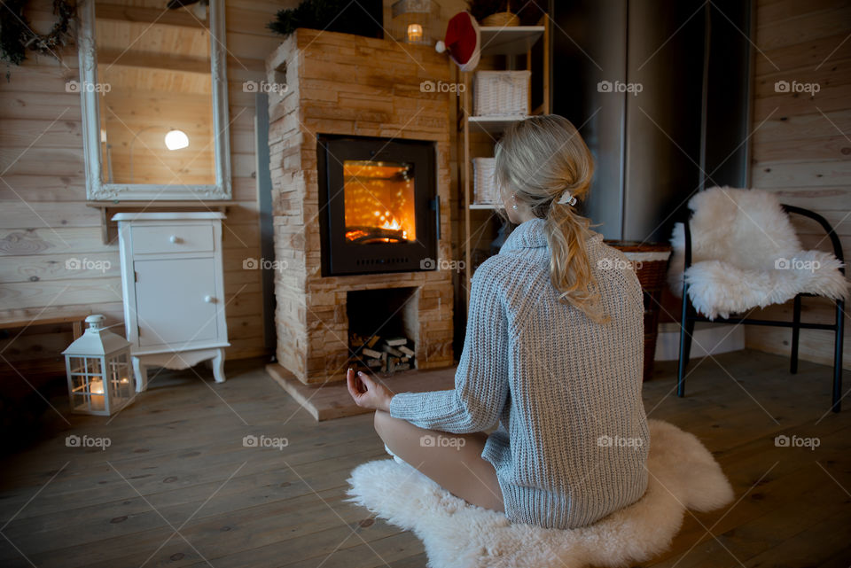 Rear view of young woman meditation at home