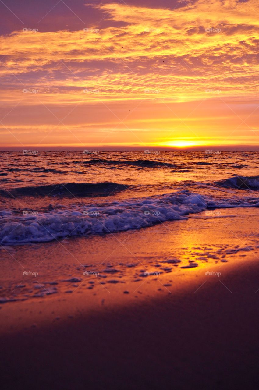 Bright sunrise over the Baltic Sea in Gdynia Poland sandy beach  