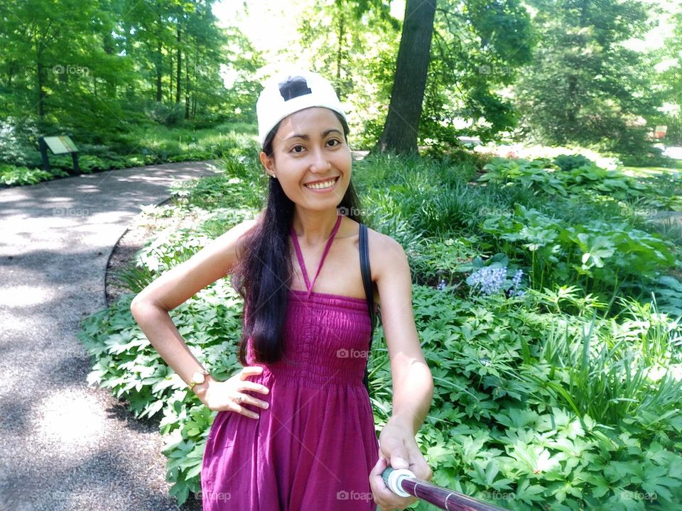 A woman holding a selfie stick 