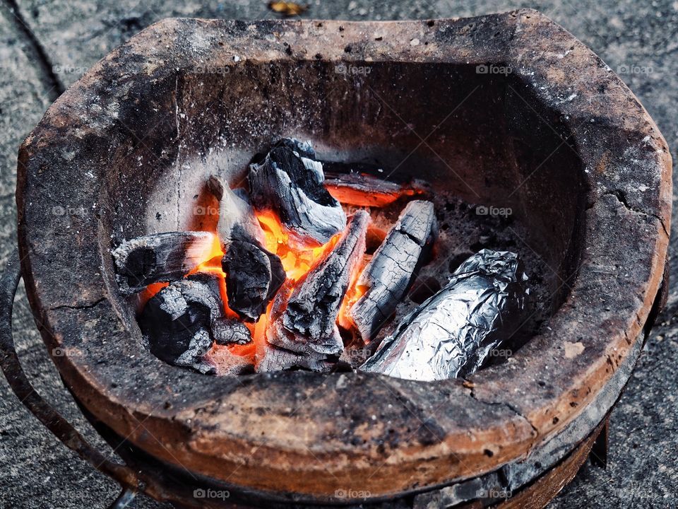 Charcoal burns in charcoal stove.