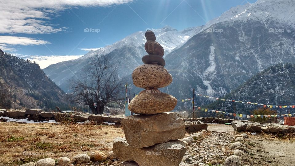 art of stones in front of roojoom guest house sangla